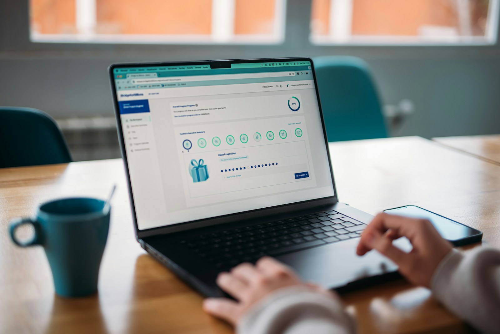 Person using a laptop to review a rewards program.